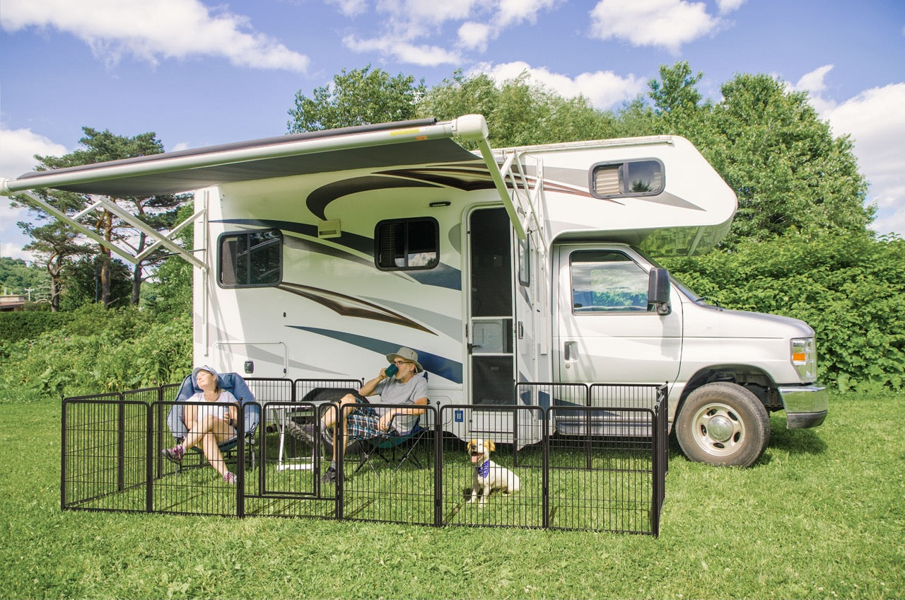 Two people rving with dog in a playpen 