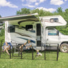 Two people rving with dog in a playpen 